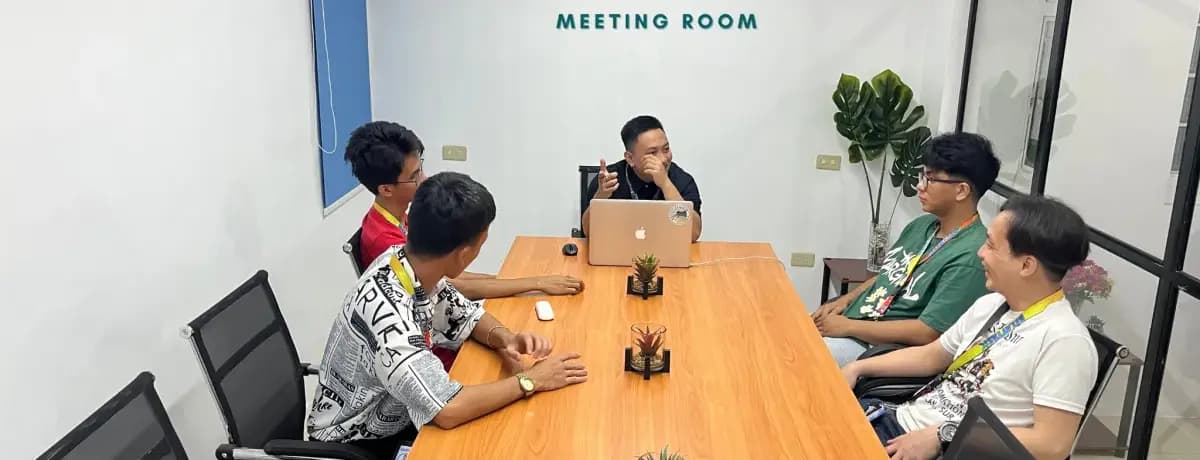 A Relaytask team briefing around the table in the Naga City office meeting room