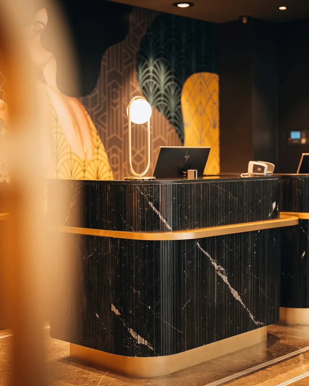 A boutique hotel reception desk in warm evening light