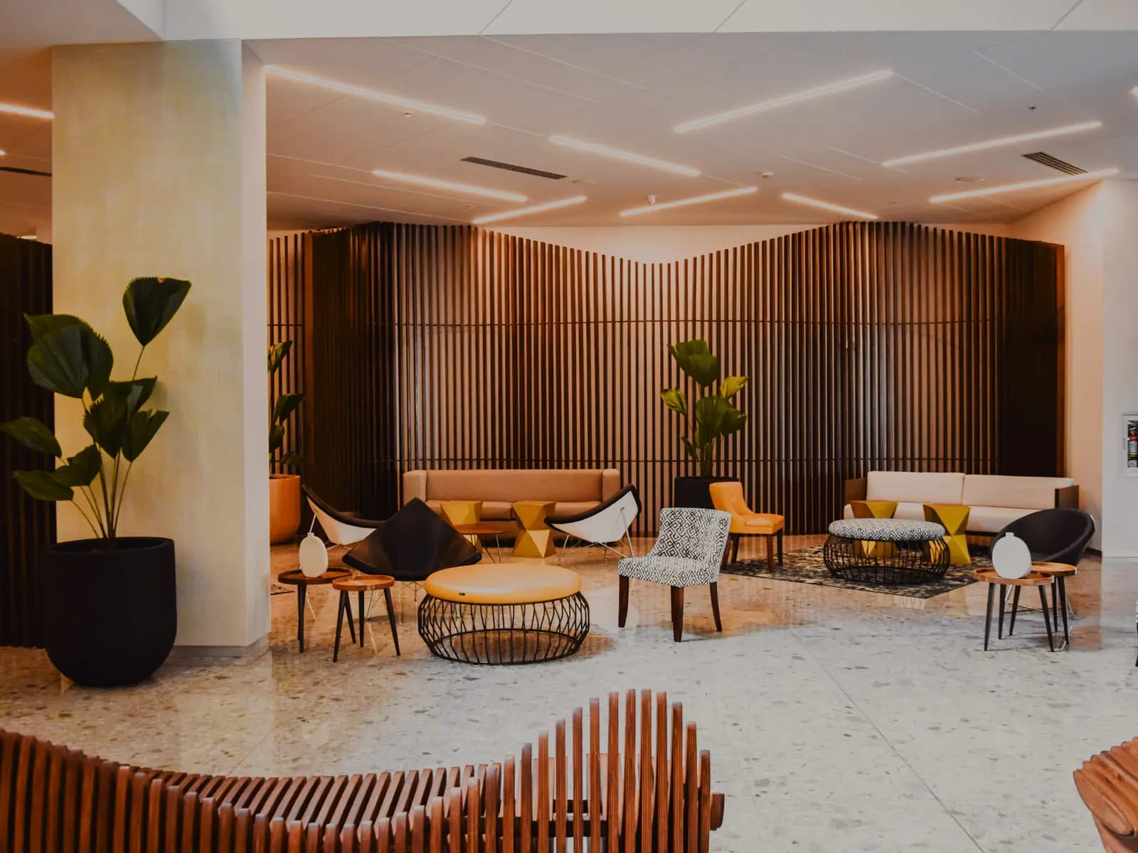 A warmly lit hotel lobby in the early evening
