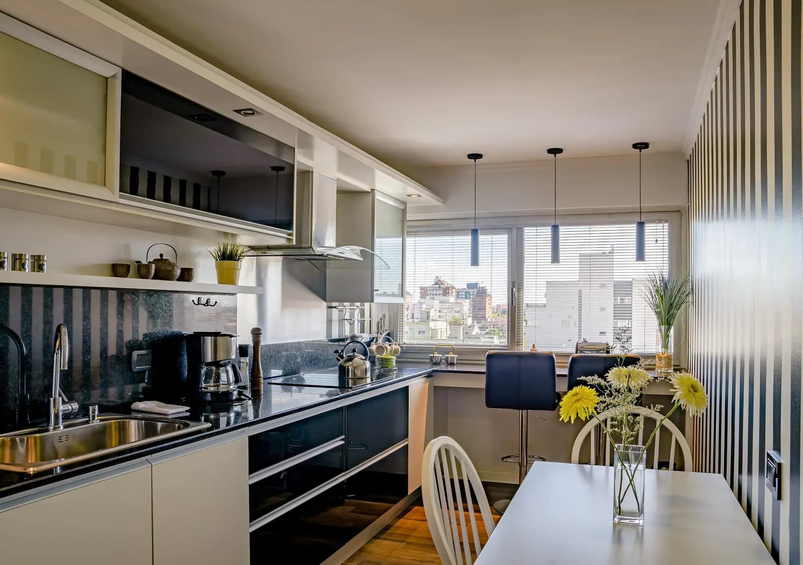 The kitchen and dining area of a furnished short-term rental apartment